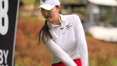 A trained student playing real golf — the swing already owned, the round already trusted.